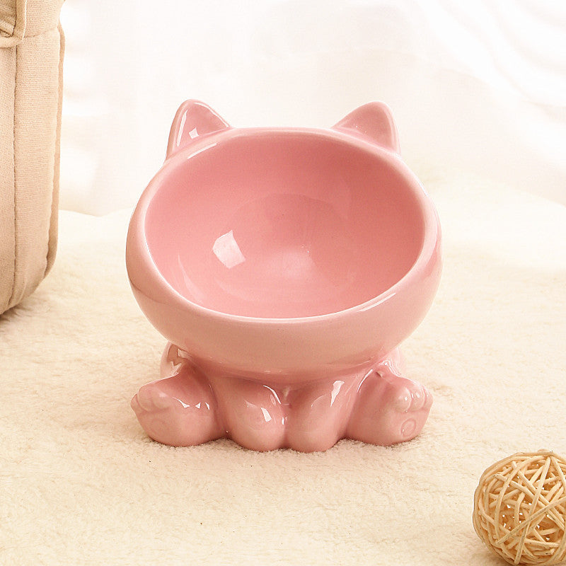 Ceramic cat bowl with paw-shaped base and oblique mouth design in pink.