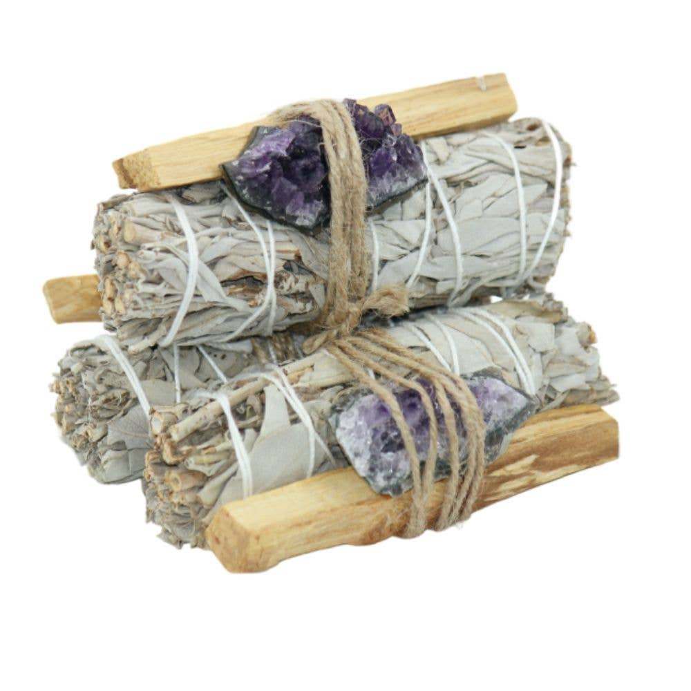 White sage bundle with palo santo sticks and raw amethyst crystals for energy cleansing and spiritual practice