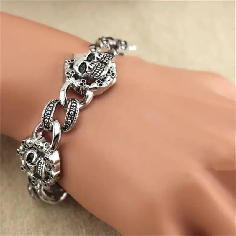 Men's bold skull metal bracelet with geometric design on a wrist.