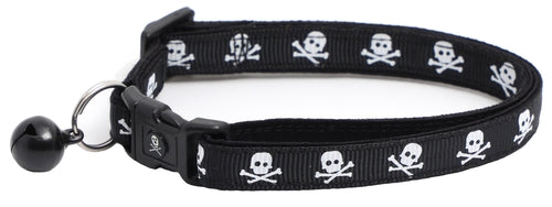 Black cat collar with skulls and crossbones design, featuring a removable bell and breakaway clip for safety.