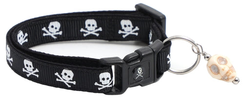 Black cat collar with skulls and crossbones design, featuring a removable bell charm.