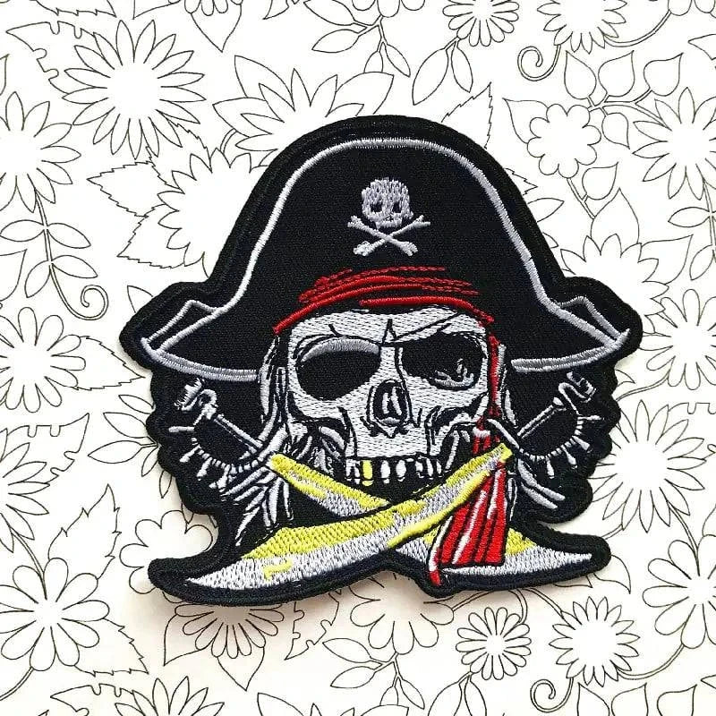 Skull motorcycle embroidered cloth sticker with pirate design on floral background.