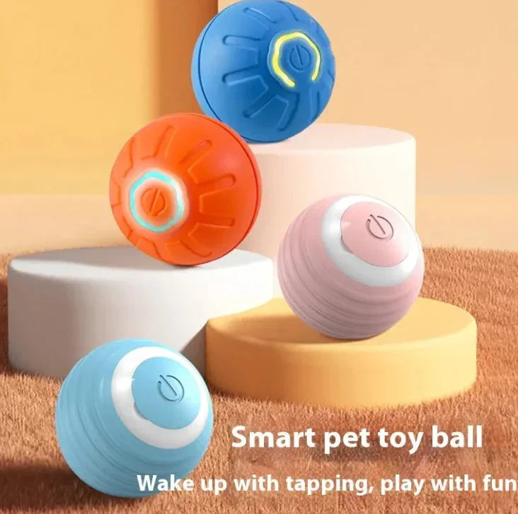 Smart Dog Toy Ball in blue, orange, and pink on display, made of silicone/ABS plastic, 42mm diameter, battery-operated.