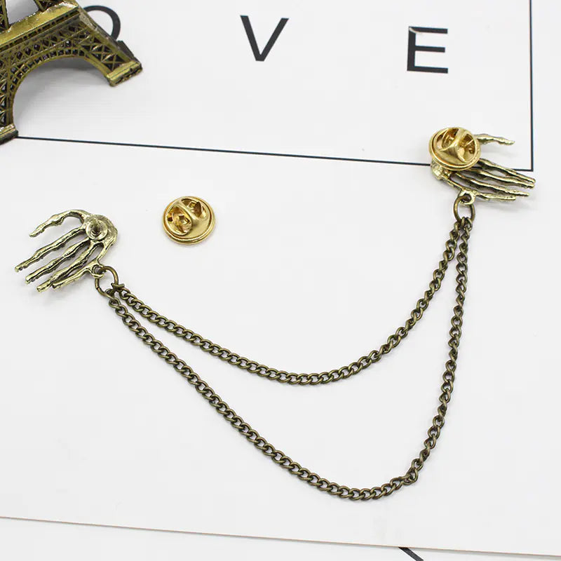 Bold Alloy Skull Claw Pin with Tassel, Electroplated Finish in Gold, Luxurious Statement Accessory.