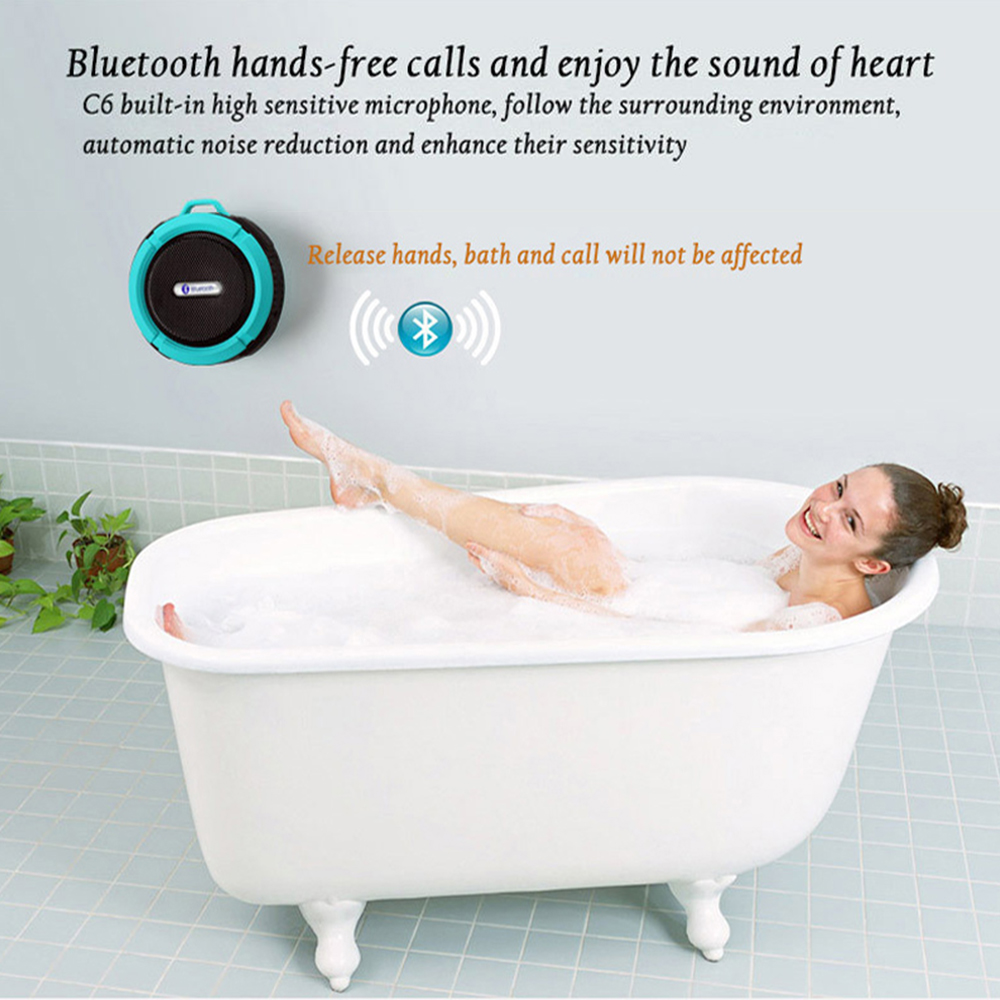 Mini portable waterproof Bluetooth speaker with suction cup in bathroom setting.