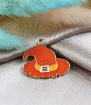 Orange witch hat charm on a fabric background