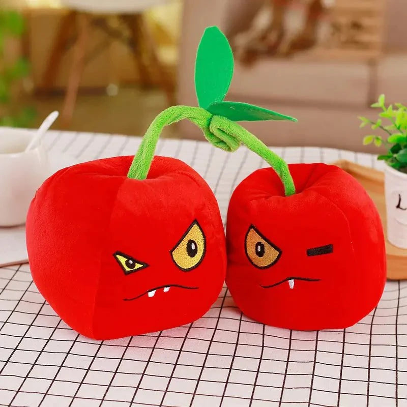 Large plush Plants vs. Zombies toys on a table, featuring vibrant red colors and playful facial expressions.