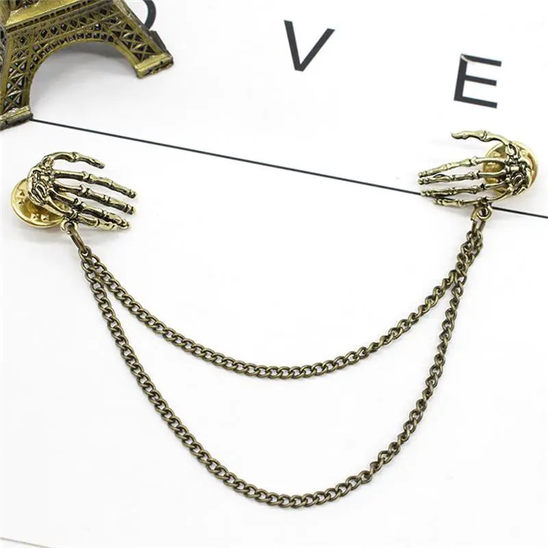 Bold Alloy Skull Claw Pin with Tassel, Electroplated Finish in Gold, Luxurious Statement Accessory.