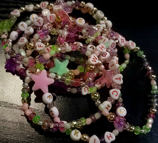 Colorful handmade friendship bracelets for adults with playful and offensive words and star-shaped beads