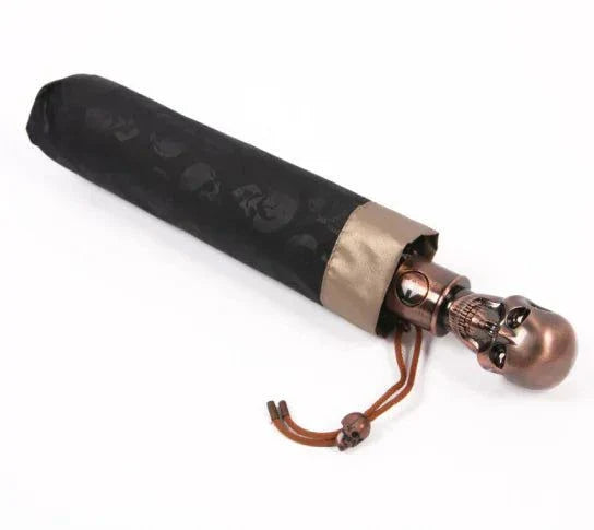 Folding umbrella with skull design, compact and durable.