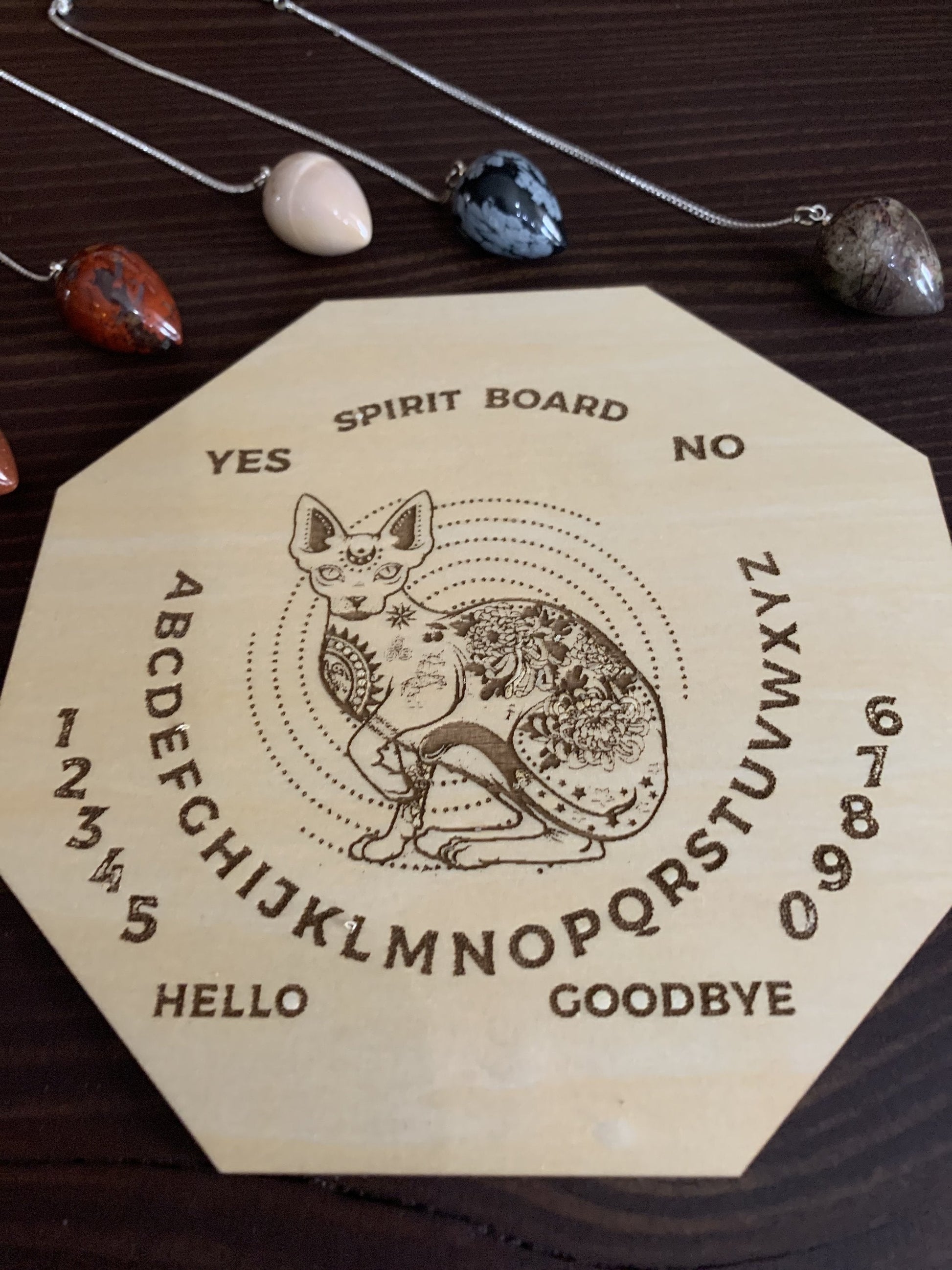 Wood Mystic Cat Pendulum Spirit Board made of maple wood with engraved mystical cat design.