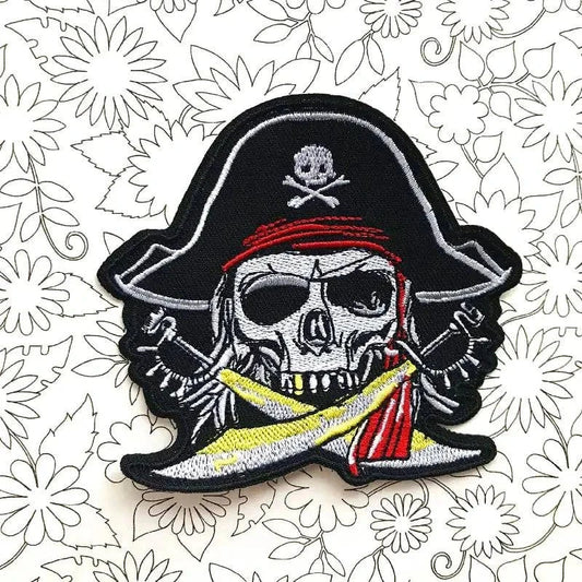 Skull motorcycle embroidered cloth sticker with pirate design on floral background.