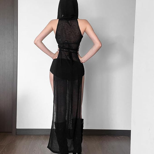 Back view of a woman wearing a black sheer gothic dress with high side slits, hood, and long wrap-around ties, styled for festival or rave outfits.