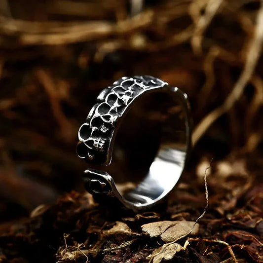 Stainless Steel Skull Ring on forest floor showcasing intricate design.