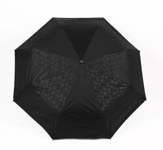 Folding umbrella with skull design and durable black canopy.