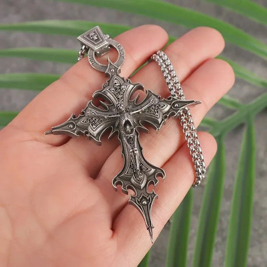 Skull cross pendant necklace with intricate detailing on a stainless steel chain.